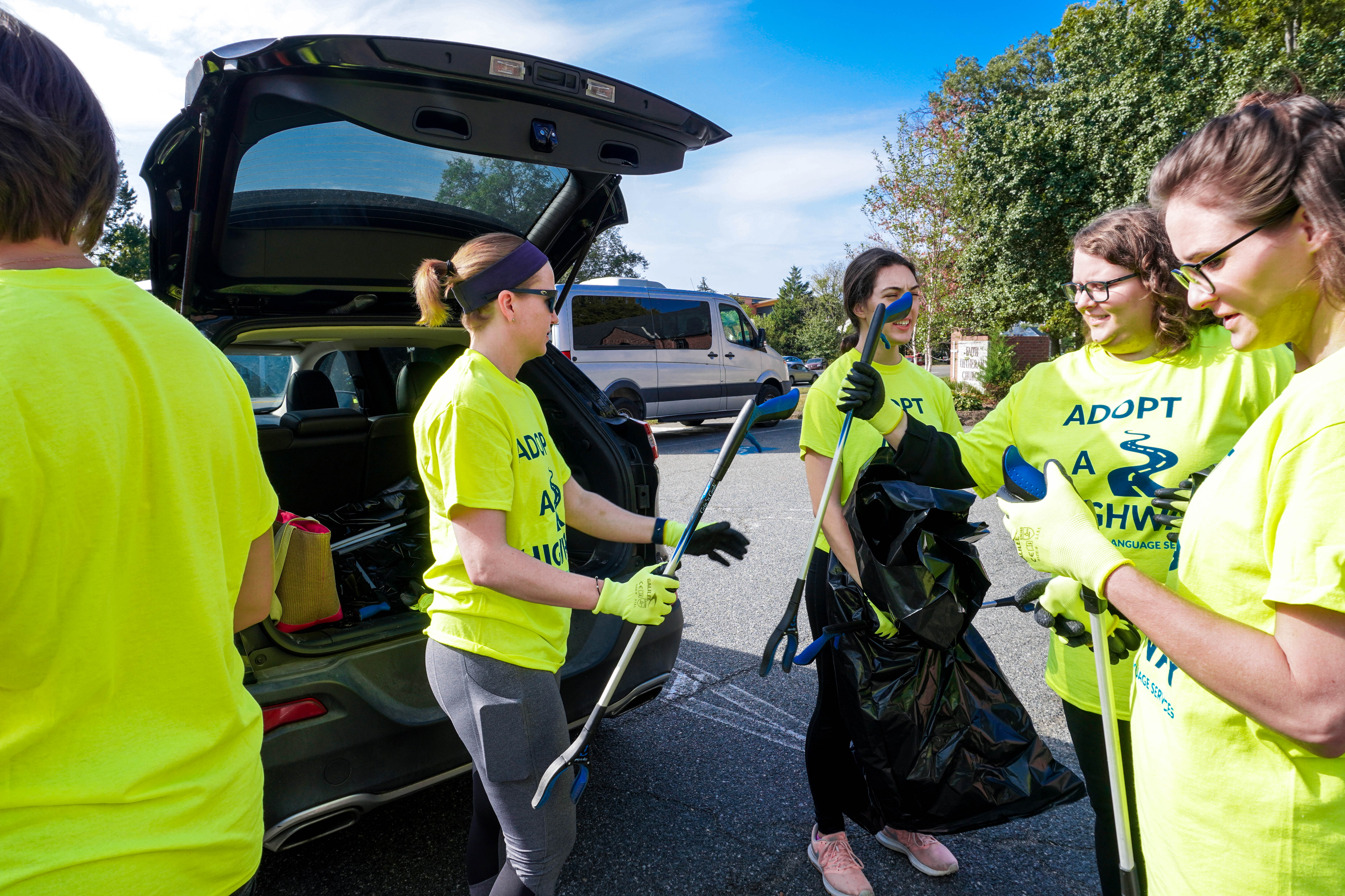 Diplomatic Language Services staff members prepare for their highway cleanup in the Washington DC metro area