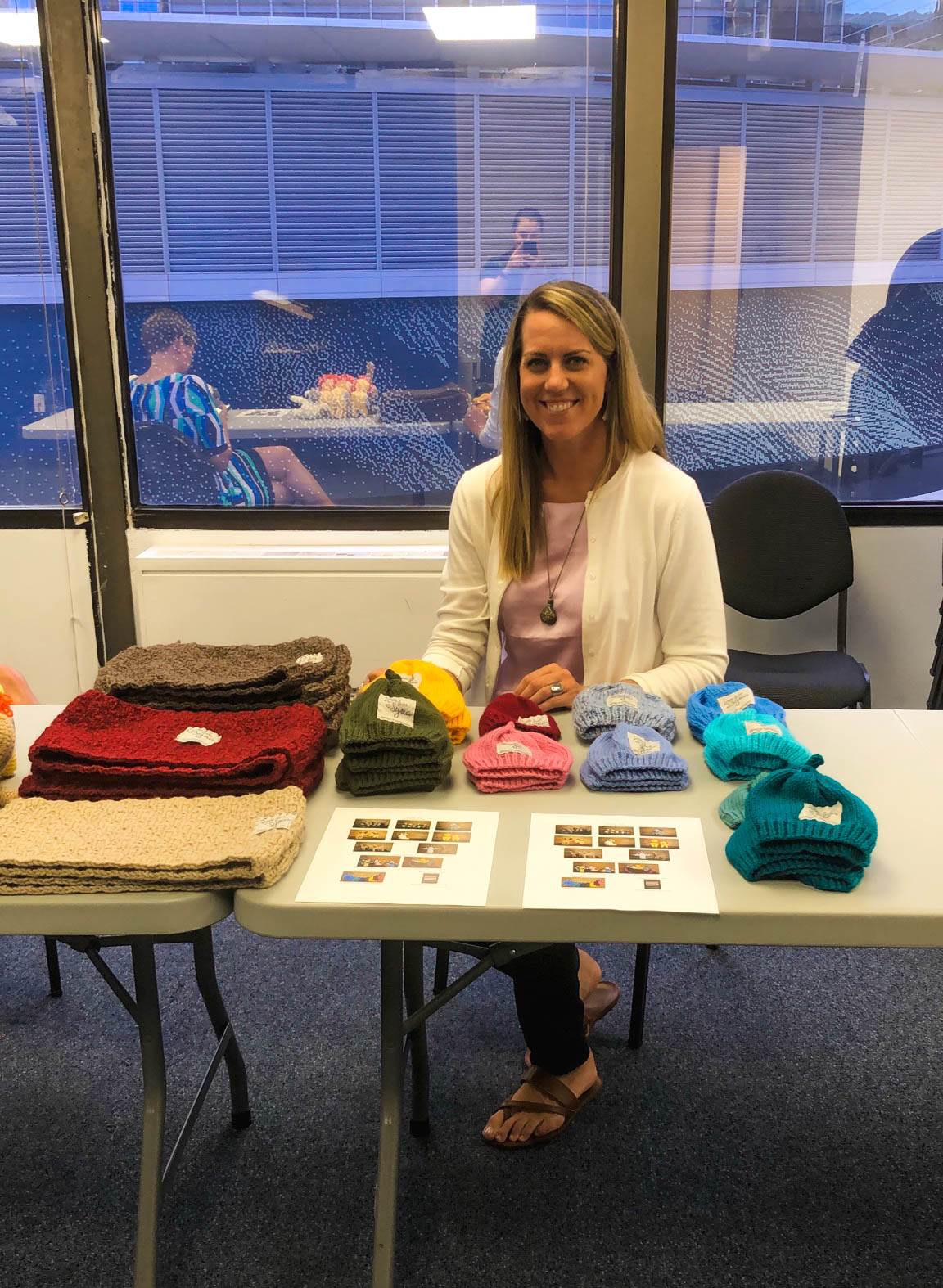 Diplomatic Language Services staff member sells handcrafted knitwear by Love For Syria nonprofit