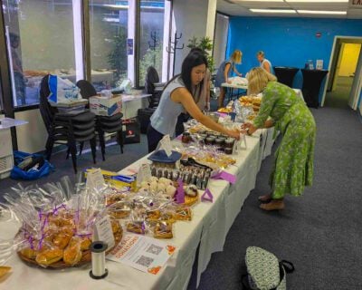 DLS bake sale table with Japanese onigiri and berry tarts for Lewy Body Dementia fundraiser
