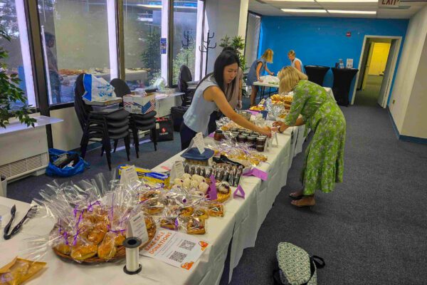 DLS bake sale table with Japanese onigiri and berry tarts for Lewy Body Dementia fundraiser